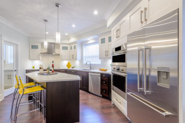 Modern, bright, clean, kitchen interior with stainless steel appliances in a luxury house